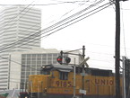 Photo of a train close to a hotel.